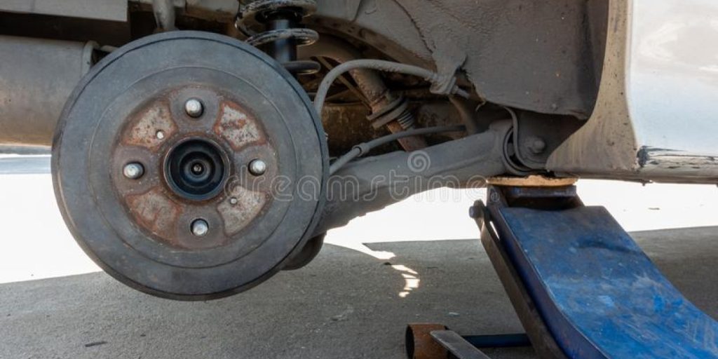 elevación-hidráulica-de-un-auto-sucio-sin-rueda-para-reparación-neumáticos-vehículo-viejo-y-levantado-por-gato-hidráulico-166078441.jpg