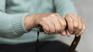 older-woman-holding-cane-hands.jpg