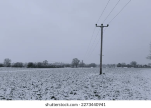 power-lines-over-farm-field-260nw-2273440941.png